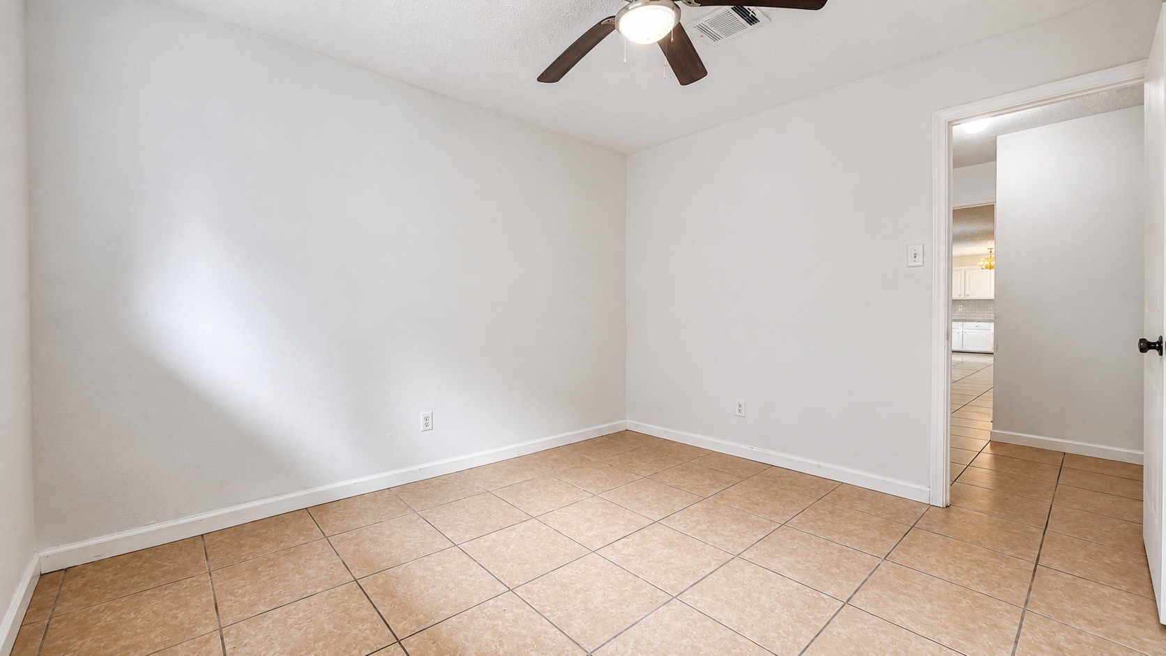 4418 Ponca Street Pasadena, TX 77504 - Photo 15 of 23 Comfortable room with neutral finishes, tile floors, and a ceiling fan. (image has been enhance for marketing purposes)