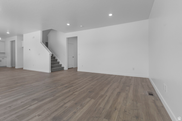 1355 West 2350 South, Unit 11 Perry, UT 84302 - Photo 12 of 39 Spacious open-concept living area featuring wood-finish flooring, recessed lighting, and crisp white walls