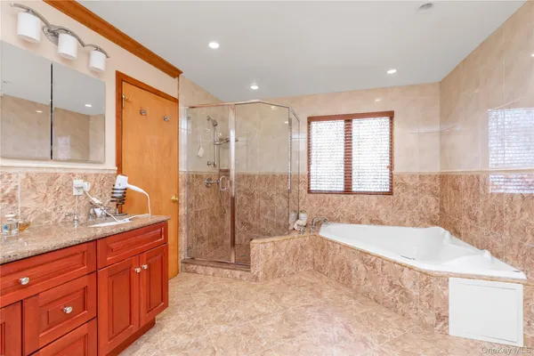 a spacious bathroom with a double vanity sink a mirror and a bathtub