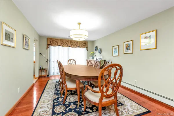 a dining room with furniture a rug and a chandelier
