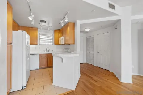 a kitchen with stainless steel appliances granite countertop a sink and a stove next to a window