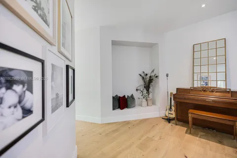 a dining room with wooden floor a chandelier a wooden table and chairs