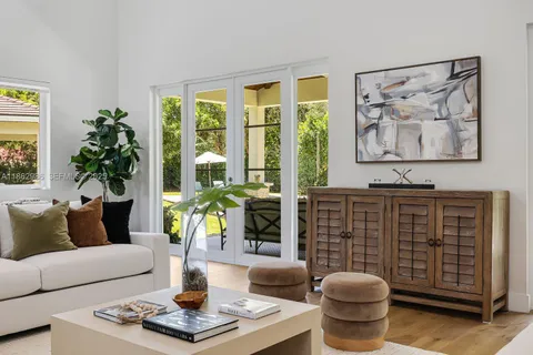a living room with furniture a window and a chandelier