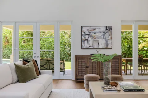 a large kitchen with kitchen island a large counter top a sink stainless steel appliances and cabinets