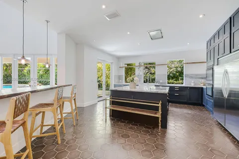 a bathroom with a granite countertop sink a toilet and a mirror