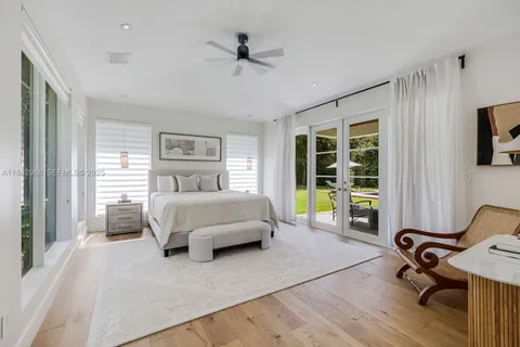 a bedroom with a bed a table and a bookshelf