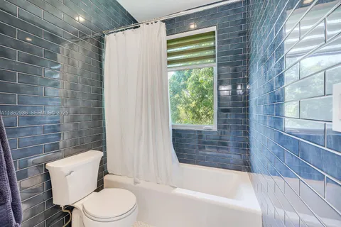 an aerial view of a house with a yard and trees