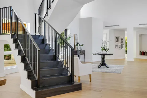 a living room with furniture potted plant and a large window
