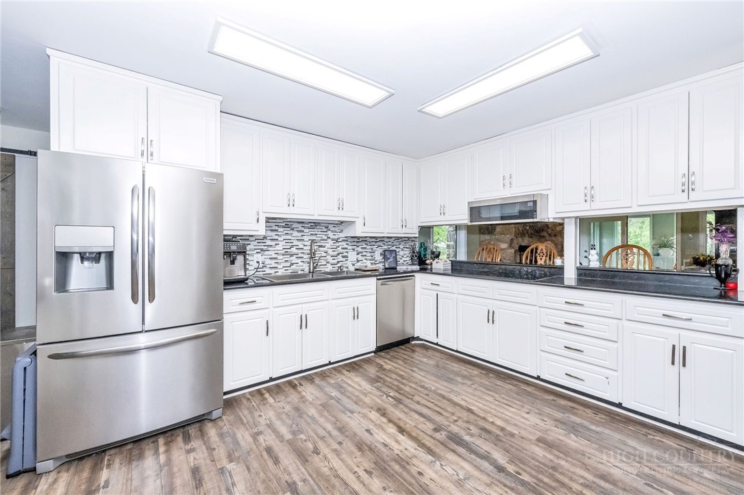 939 Don Bare Road Jefferson, NC 28640 - Photo 6 of 49 a kitchen with granite countertop white cabinets and white stainless steel appliances