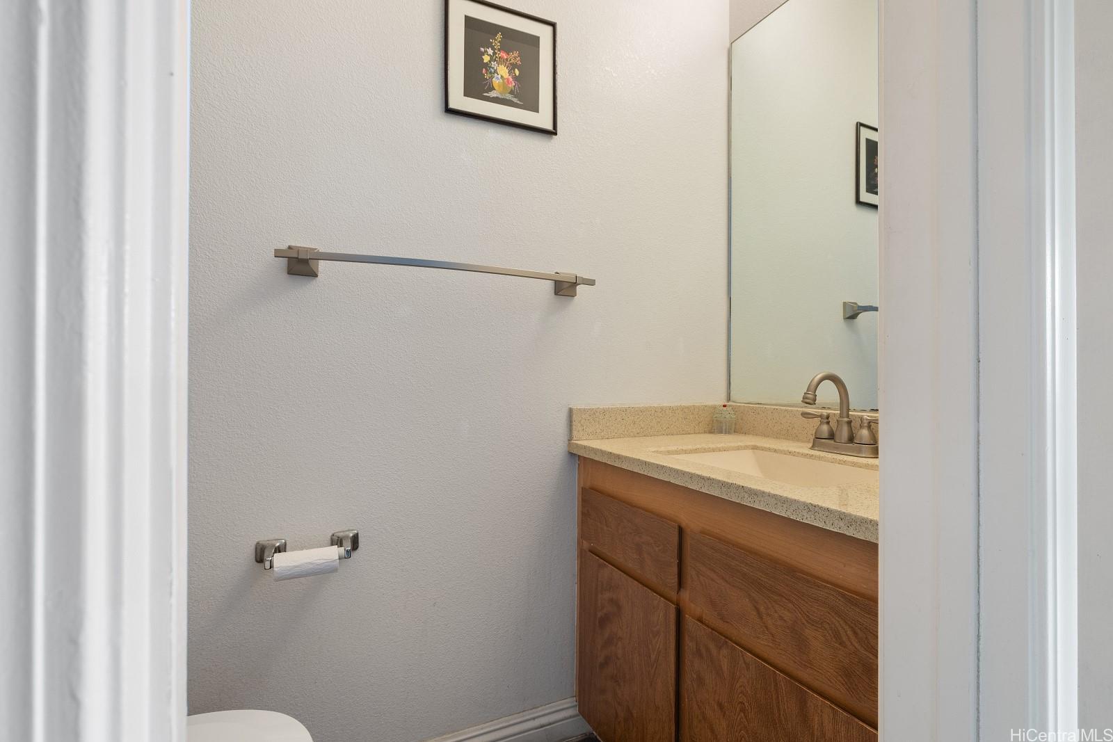 98-660 Moanalua Loop, Unit 276 Aiea, HI 96701 - Photo 12 of 25 a bathroom with a sink and vanity