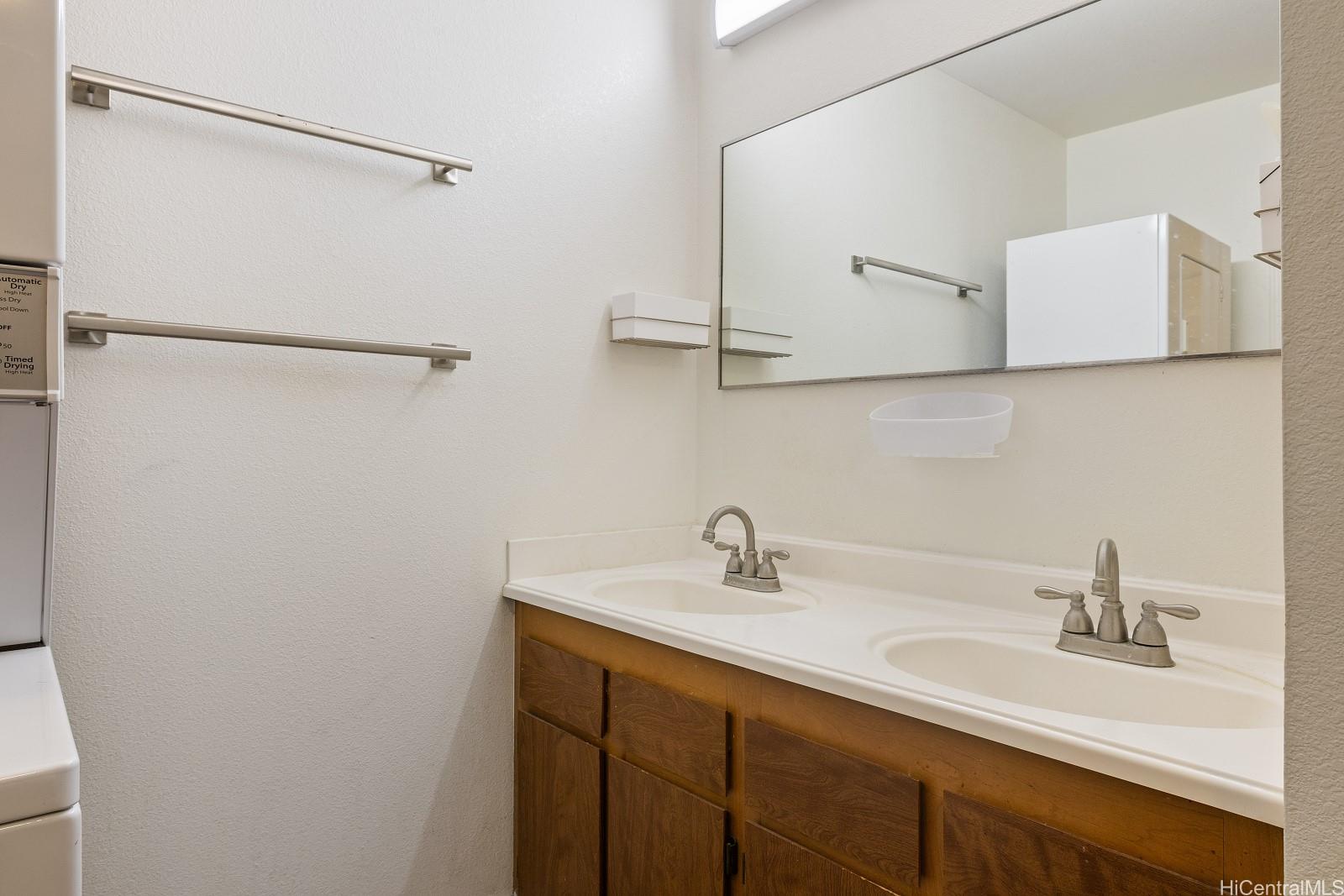 98-660 Moanalua Loop, Unit 276 Aiea, HI 96701 - Photo 14 of 25 a bathroom with a sink and mirror