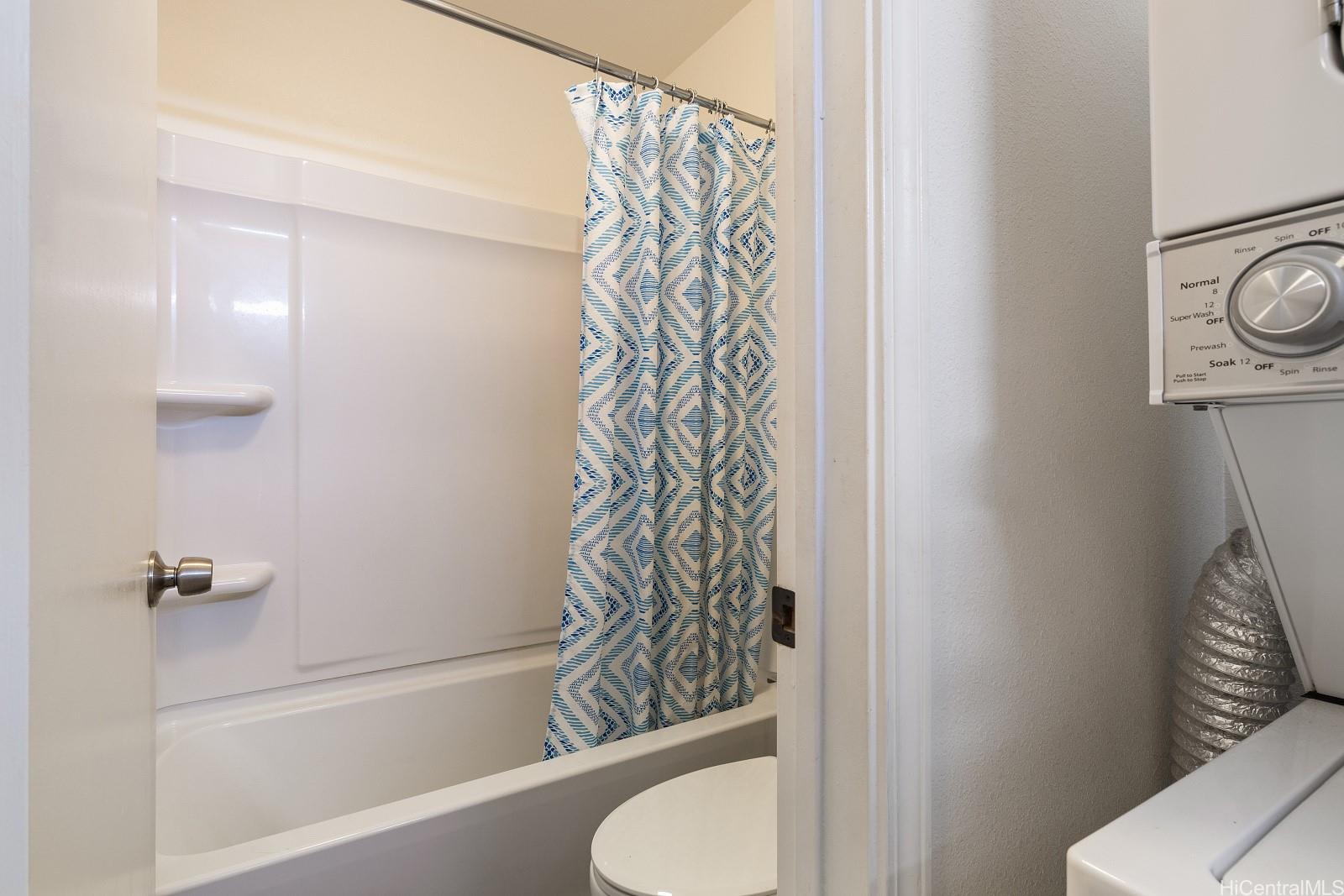 98-660 Moanalua Loop, Unit 276 Aiea, HI 96701 - Photo 15 of 25 a bathroom with a shower curtain and a toilet