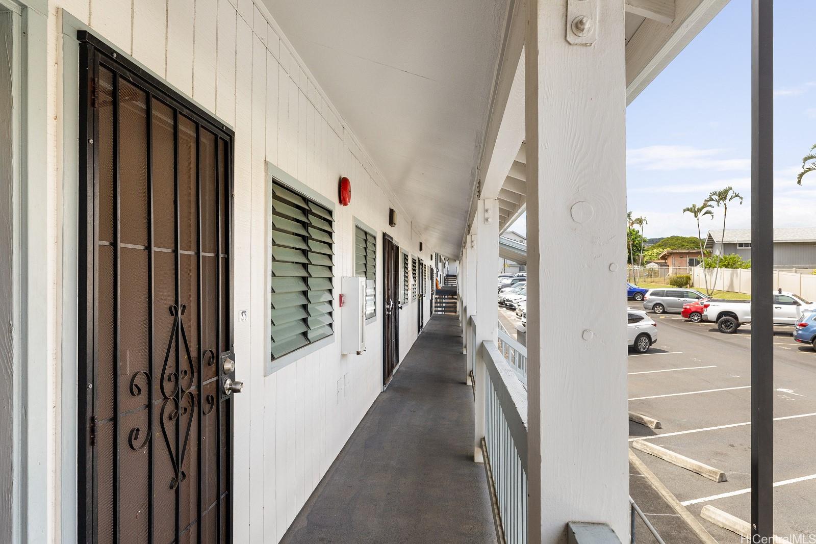 98-660 Moanalua Loop, Unit 276 Aiea, HI 96701 - Photo 17 of 25 a view of a hallway with wooden floor and staircase
