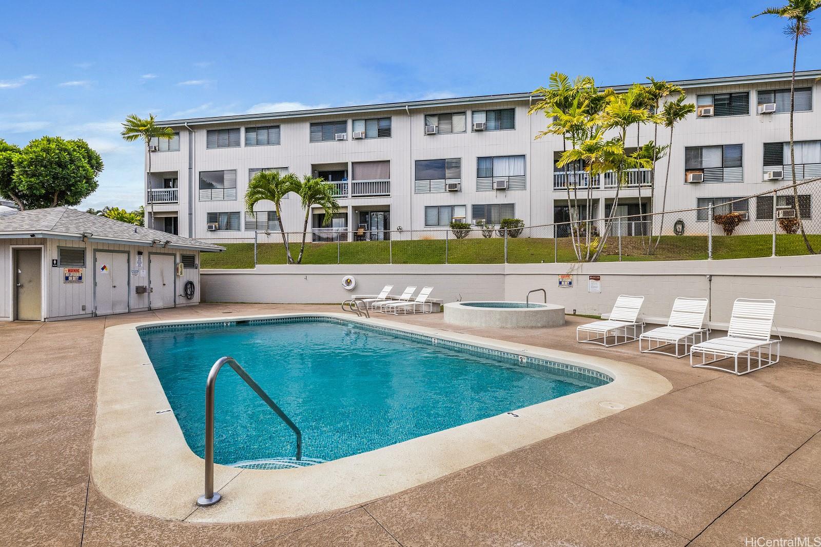 98-660 Moanalua Loop, Unit 276 Aiea, HI 96701 - Photo 18 of 25 a view of a building with a swimming pool and sitting area