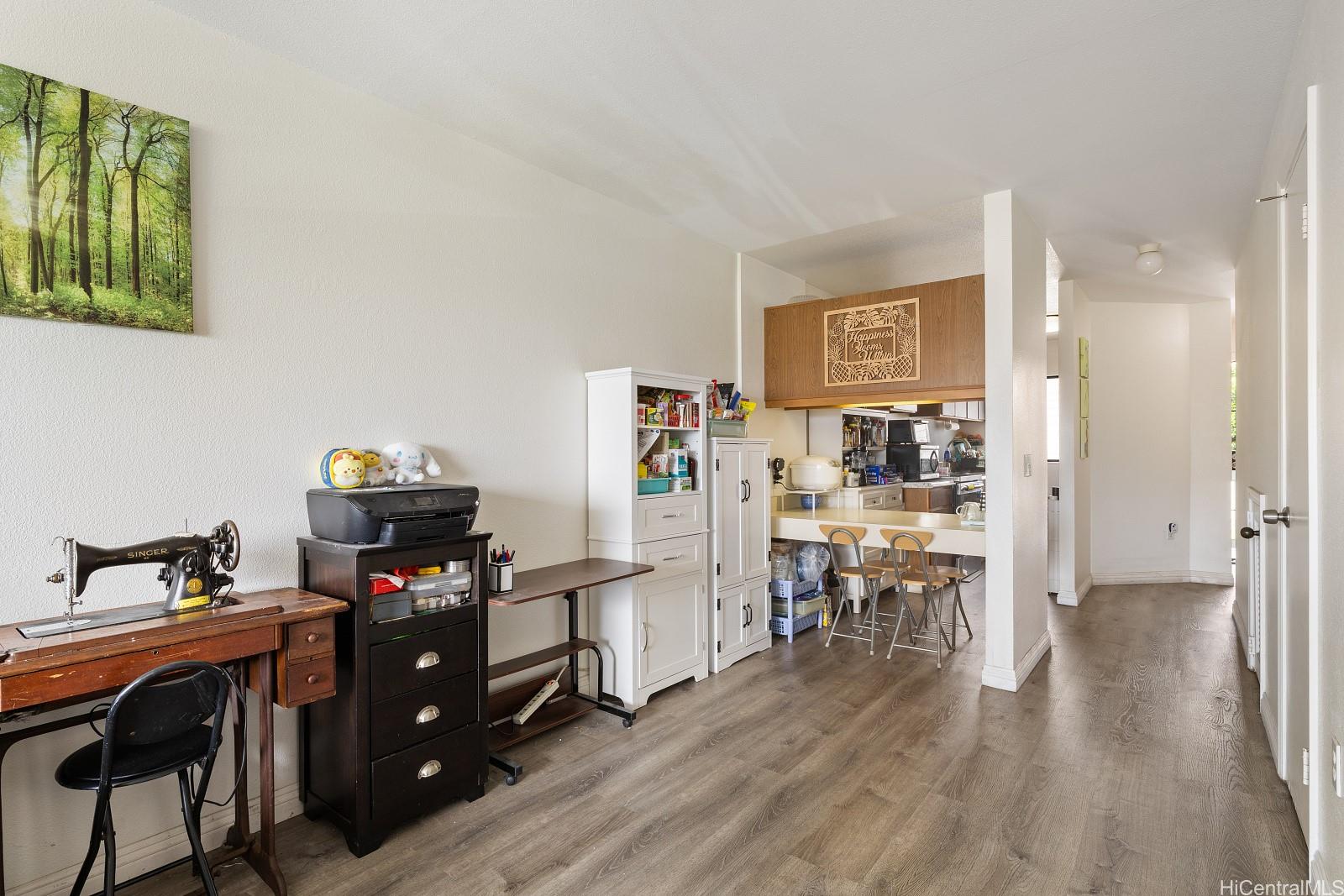 98-660 Moanalua Loop, Unit 276 Aiea, HI 96701 - Photo 4 of 25 a view of a workspace with furniture and wooden floor