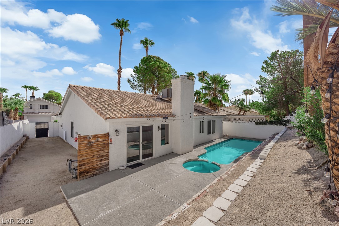 1433 Pathfinder Road Henderson, NV 89014 - Photo 31 of 35 An inviting backyard oasis features a concrete patio alongside a private pool and spa.
