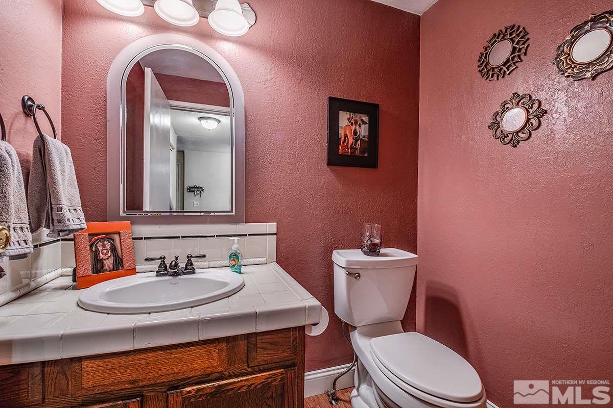 2642 Rayma Court Reno, NV 89503 - Photo 12 of 22 a bathroom with a toilet a sink and mirror