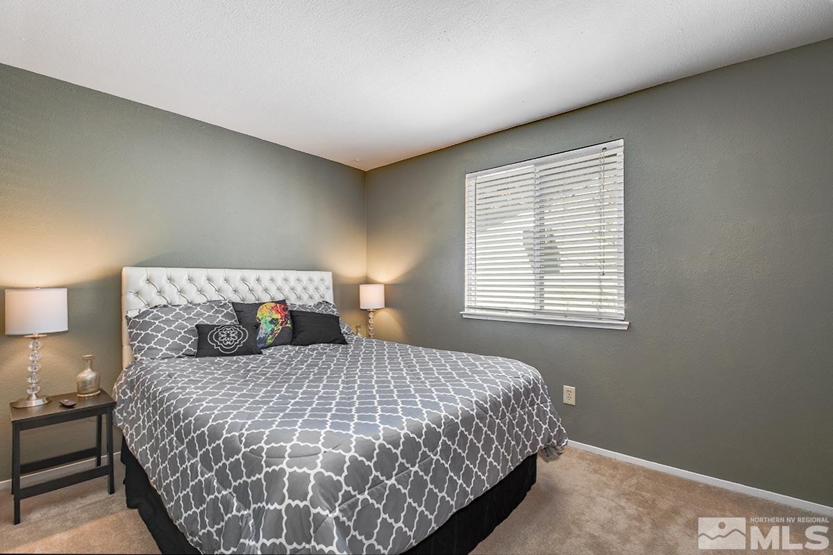 2642 Rayma Court Reno, NV 89503 - Photo 14 of 22 a bedroom with a large bed and a window