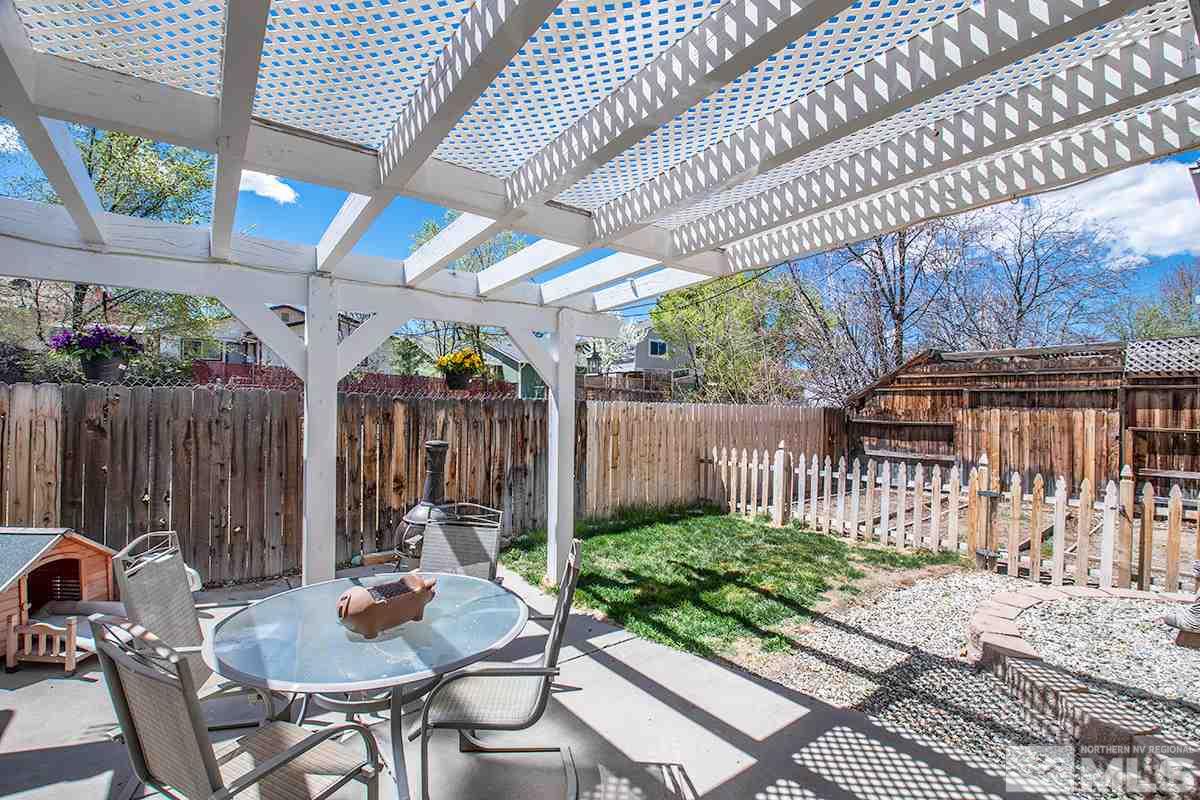 2642 Rayma Court Reno, NV 89503 - Photo 20 of 22 a view of a patio with table and chairs with wooden fence and plants