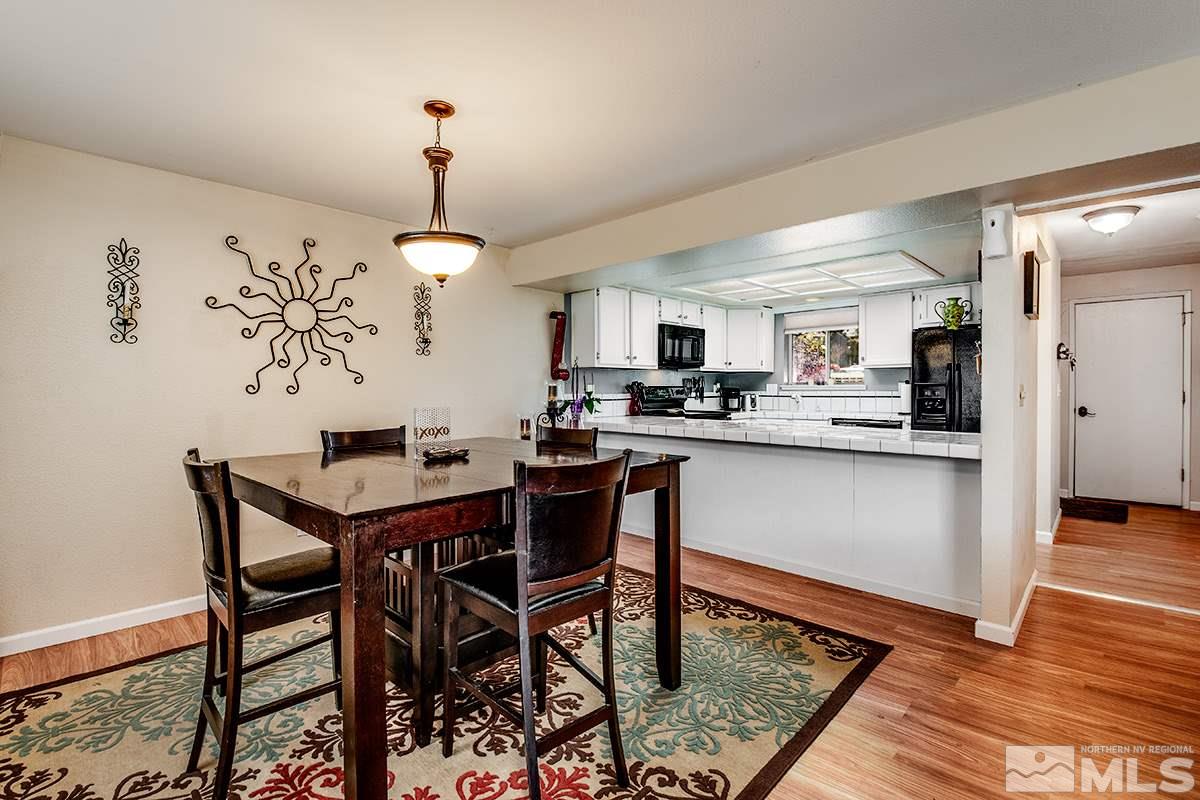 2642 Rayma Court Reno, NV 89503 - Photo 5 of 22 a kitchen with stainless steel appliances granite countertop a dining table chairs and a refrigerator