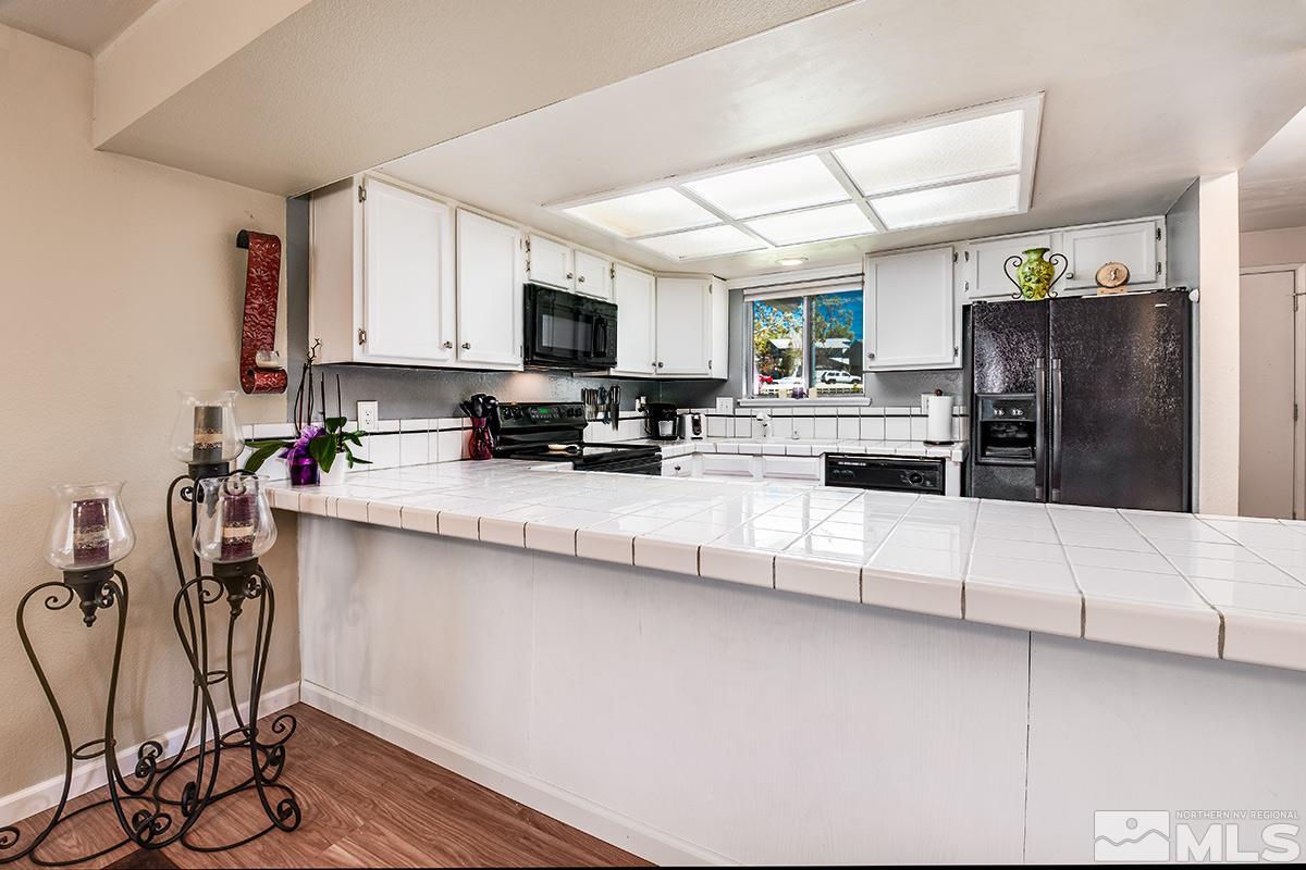 2642 Rayma Court Reno, NV 89503 - Photo 8 of 22 a kitchen with stainless steel appliances a stove a sink a refrigerator a center island and a refrigerator
