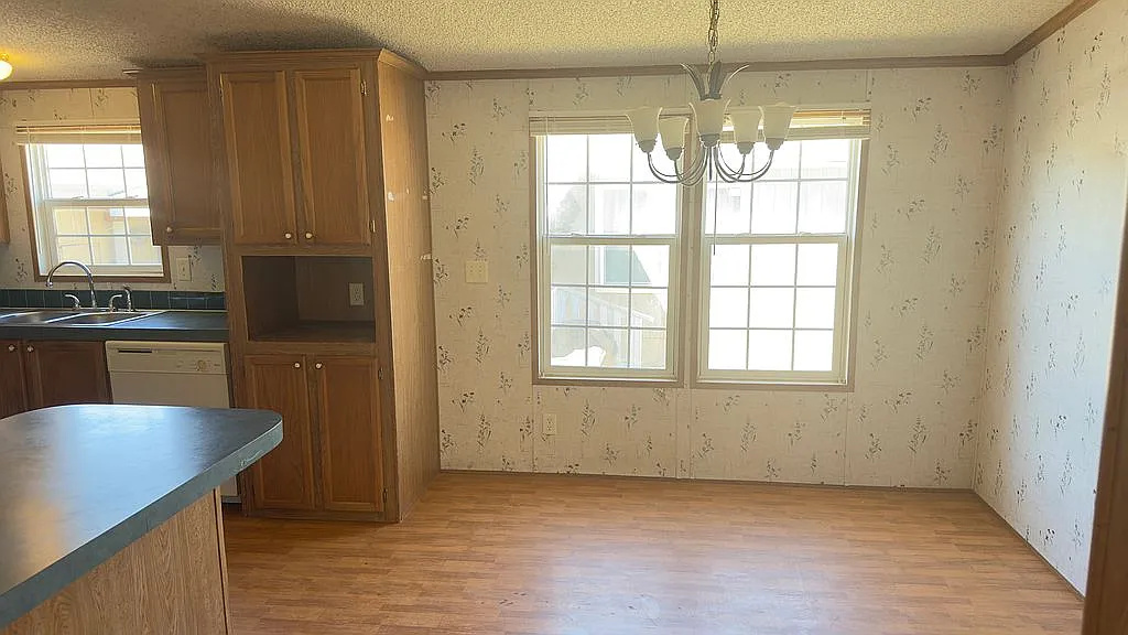 2607 George Street Round Rock, TX 78681 - Photo 12 of 14 an empty room with windows and chandelier