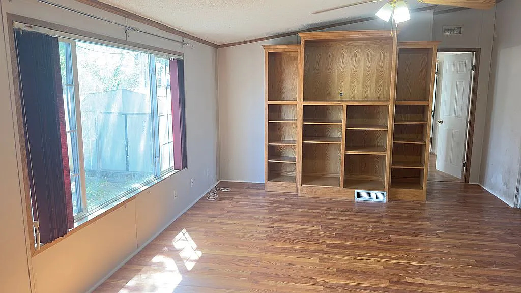 2607 George Street Round Rock, TX 78681 - Photo 7 of 14 a view of a room with wooden floor and windows