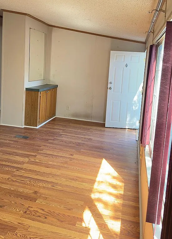 2607 George Street Round Rock, TX 78681 - Photo 10 of 14 a view of a room with wooden floor and cabinet