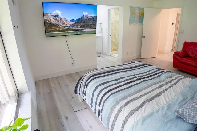 a bedroom with a bed and a painting on the wall