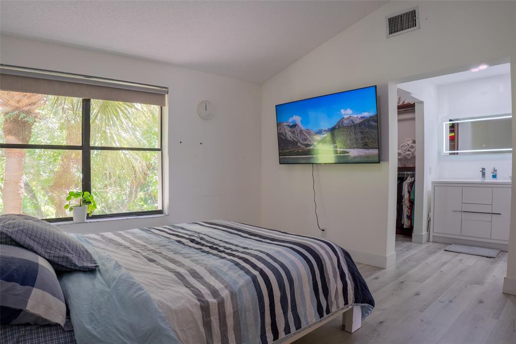 361 Southwest 95 Terrace, Unit 361 Pembroke Pines, FL 33025 - Photo 12 of 14 a bedroom with a bed and a flat screen tv