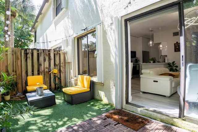 a view of a patio with couple of chairs and a fountain