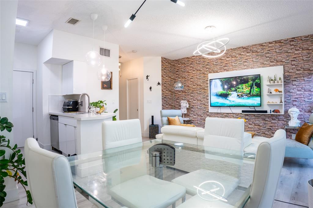 361 Southwest 95 Terrace, Unit 361 Pembroke Pines, FL 33025 - Photo 3 of 14 a living room with furniture a flat screen tv and a fireplace
