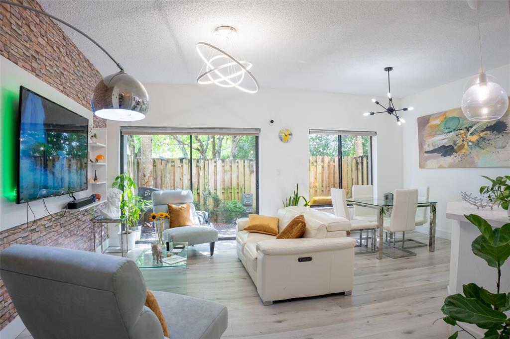 361 Southwest 95 Terrace, Unit 361 Pembroke Pines, FL 33025 - Photo 5 of 14 a living room with furniture and a chandelier