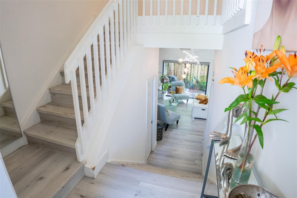 361 Southwest 95 Terrace, Unit 361 Pembroke Pines, FL 33025 - Photo 7 of 14 a hallway with wooden floor and a potted plant