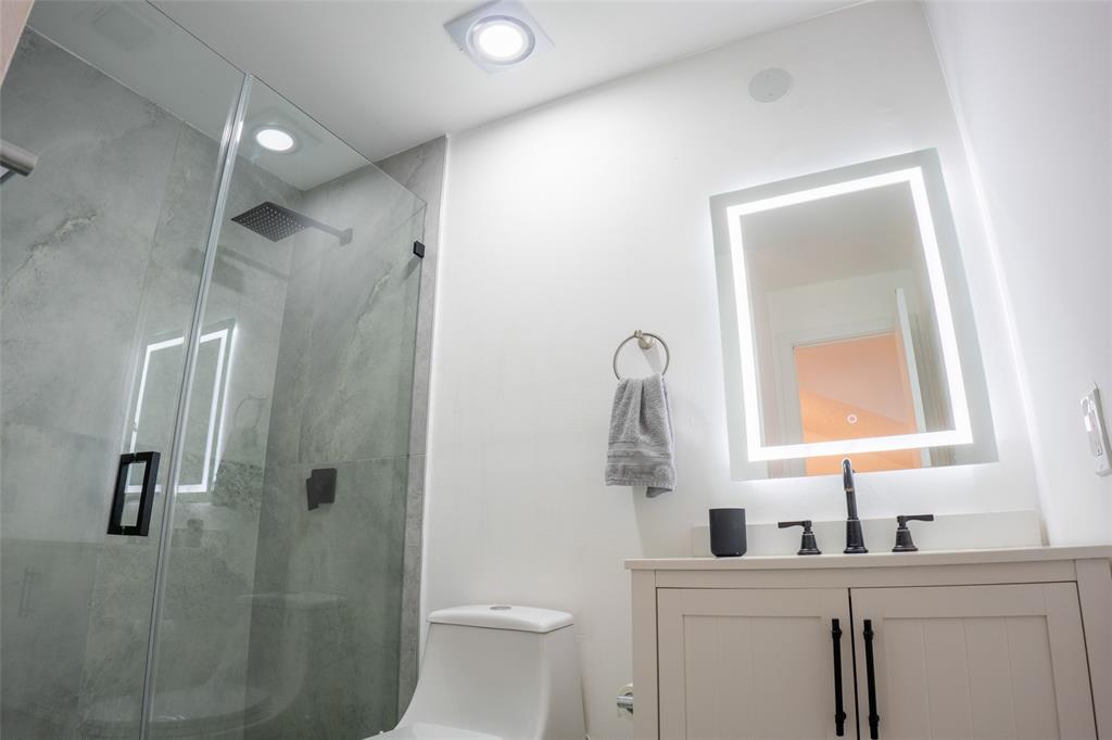 361 Southwest 95 Terrace, Unit 361 Pembroke Pines, FL 33025 - Photo 9 of 14 a bathroom with a toilet sink a shower and vanity