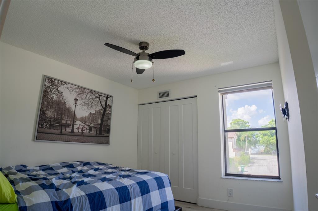 361 Southwest 95 Terrace, Unit 361 Pembroke Pines, FL 33025 - Photo 10 of 14 a bedroom with a large bed and a window