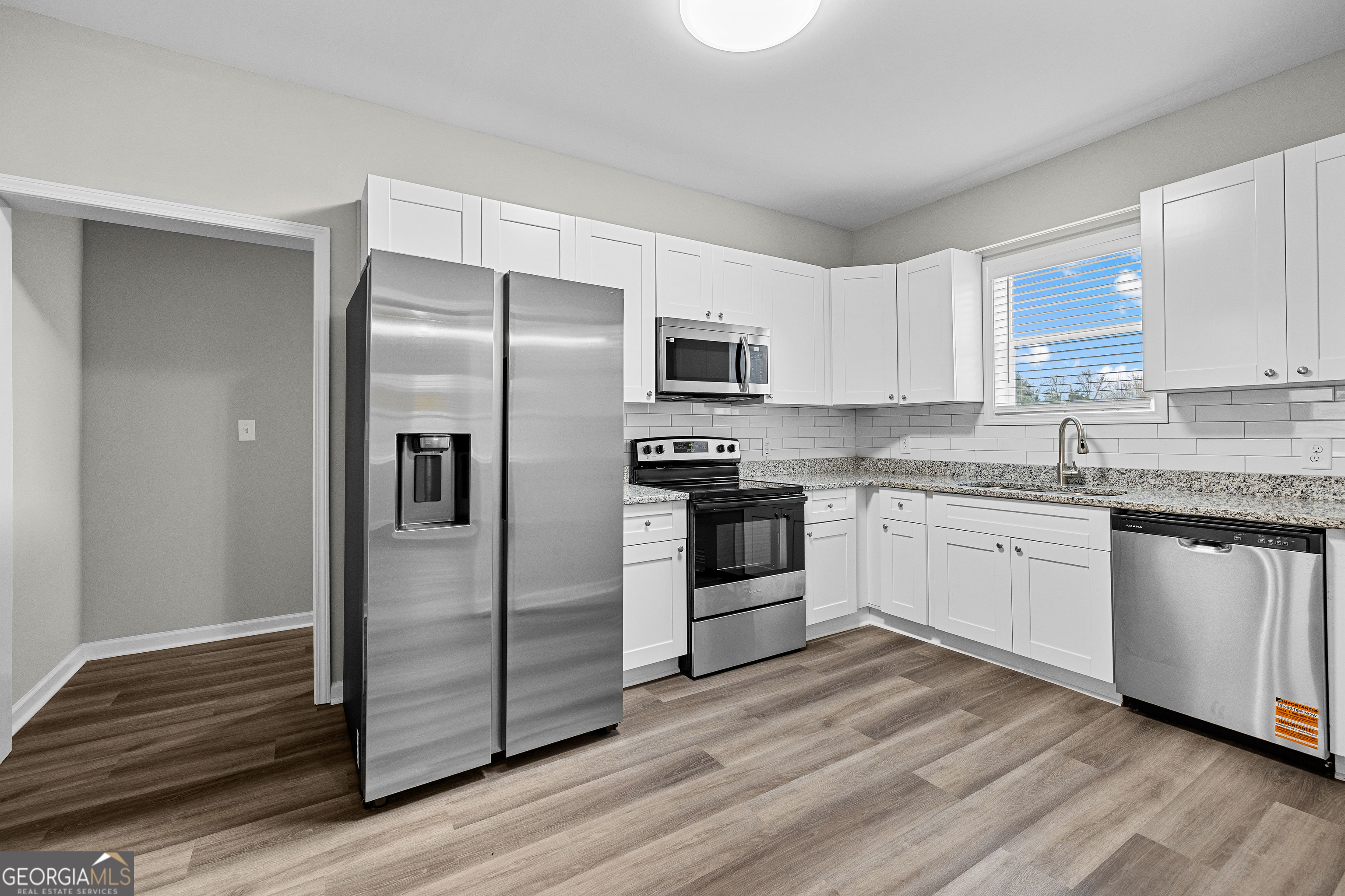 21 Shepard Street Grantville, GA 30220 - Photo 12 of 29 a kitchen with granite countertop a refrigerator and a stove top oven