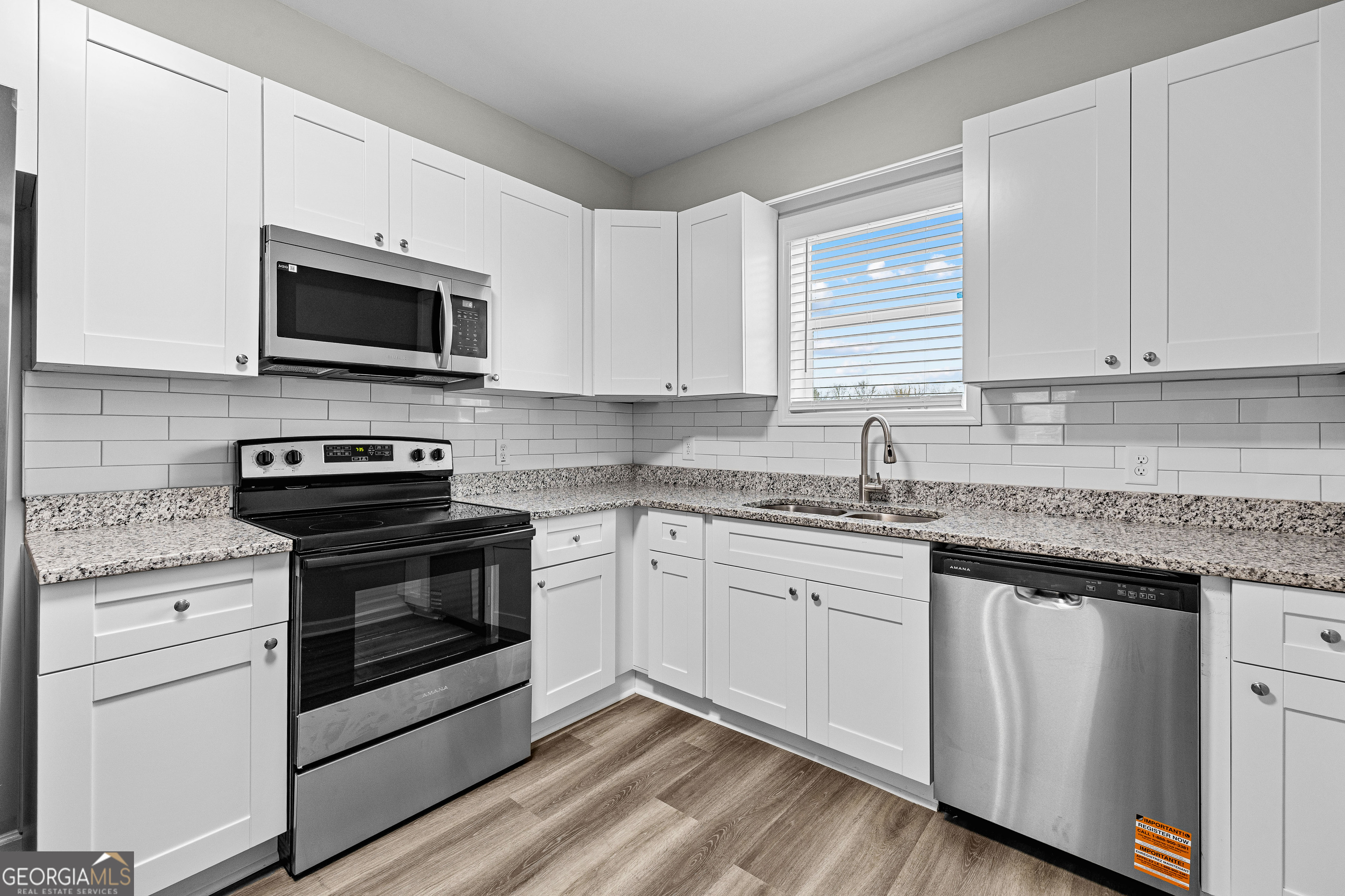 21 Shepard Street Grantville, GA 30220 - Photo 13 of 29 a kitchen with granite countertop white cabinets stainless steel appliances and a sink
