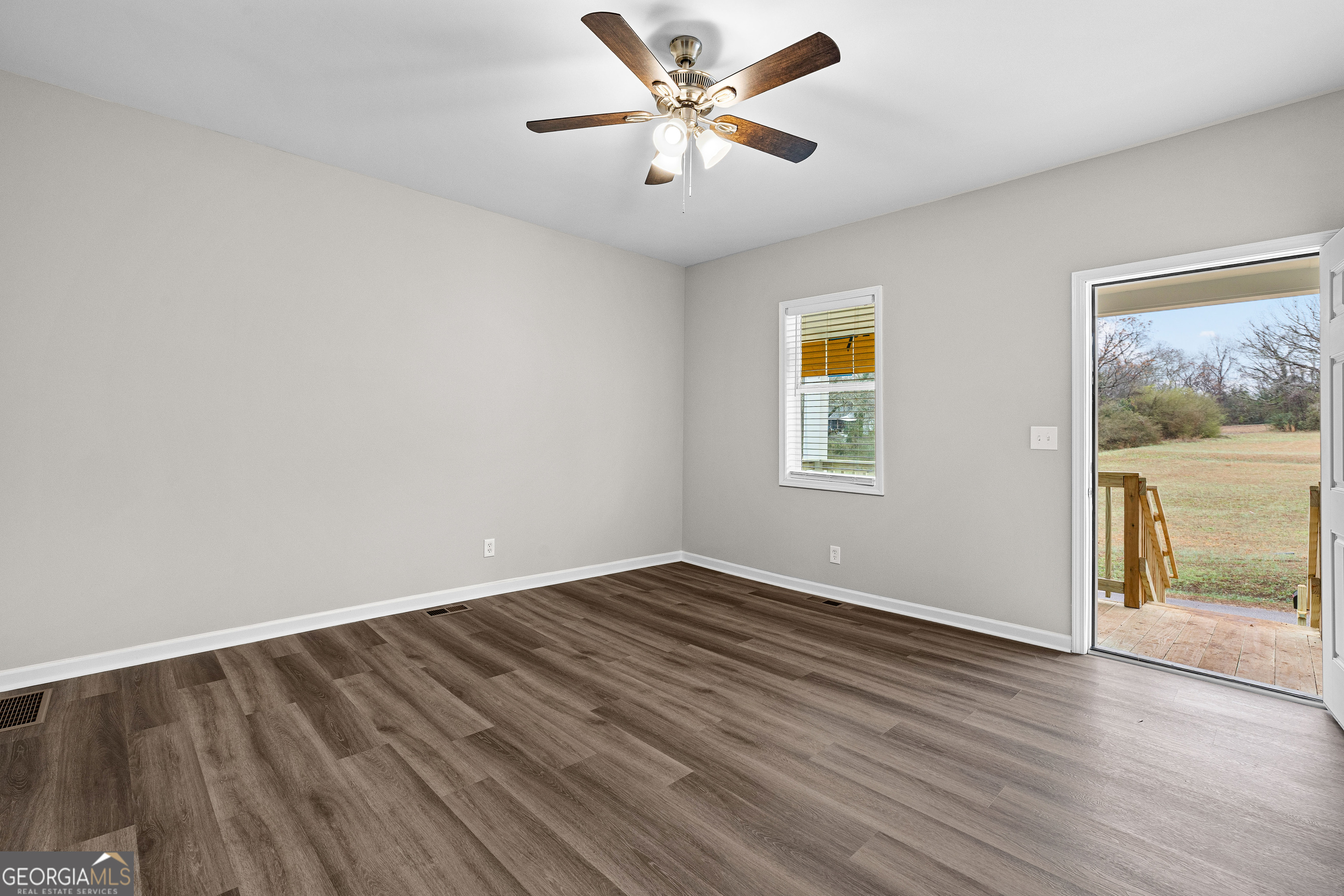 21 Shepard Street Grantville, GA 30220 - Photo 5 of 29 wooden floor in an empty room with a window