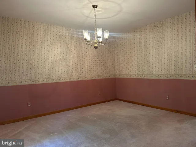 a view of a room with a ceiling fan and a window