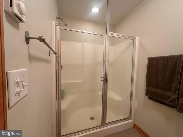 a bathroom with a glass shower door