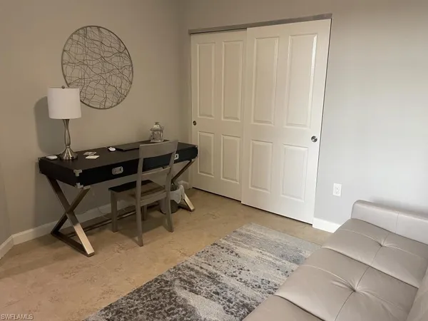 a bed sitting in a bedroom next to a bathroom