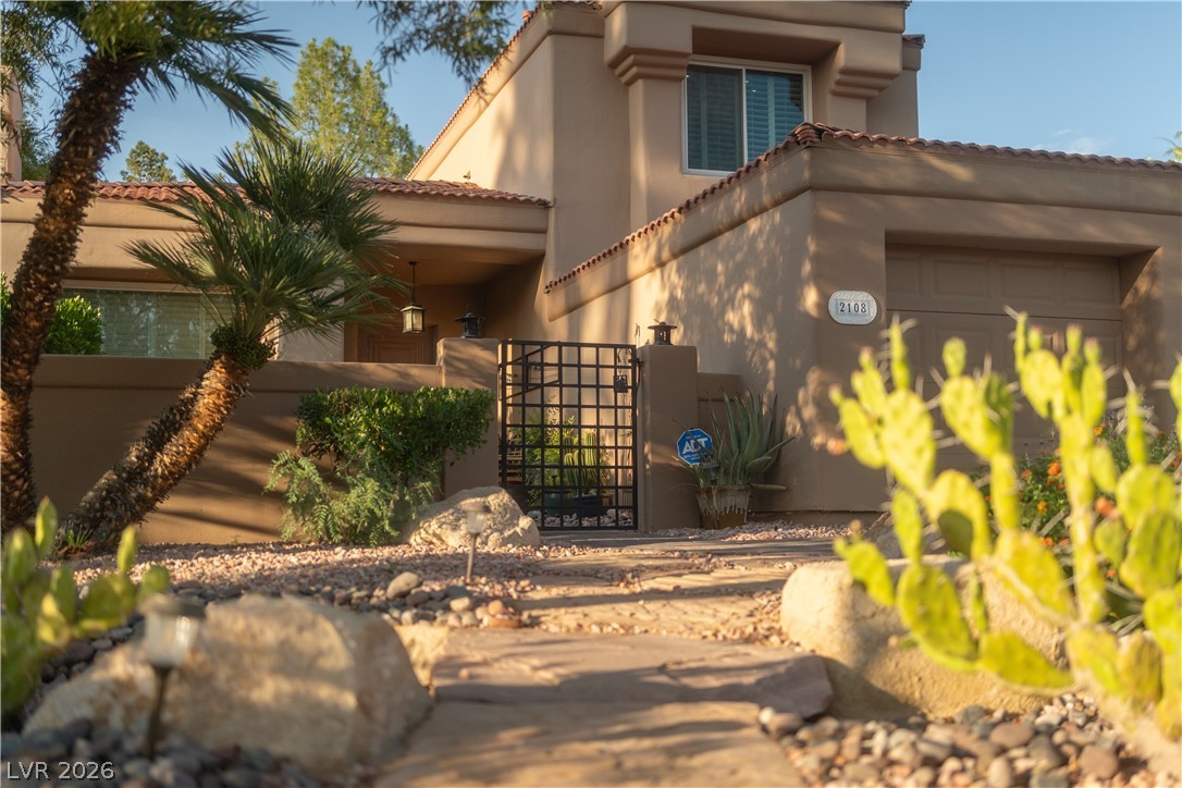 2108 Inverness Drive Henderson, NV 89074 - Photo 39 of 46 Mediterranean / spanish-style house with a gate, a tiled roof, and stucco siding
