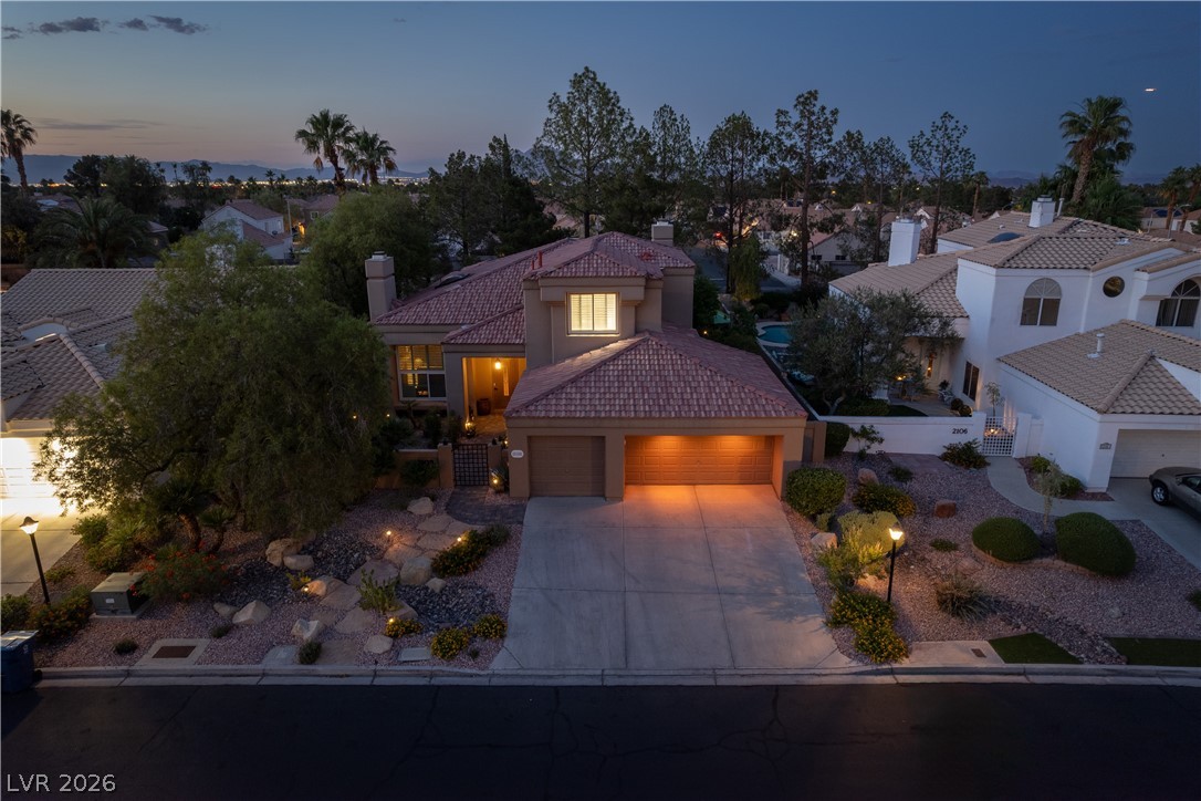 2108 Inverness Drive Henderson, NV 89074 - Photo 41 of 46 Mediterranean / spanish-style house featuring a tiled roof, an attached garage, concrete driveway, a chimney, and stucco siding