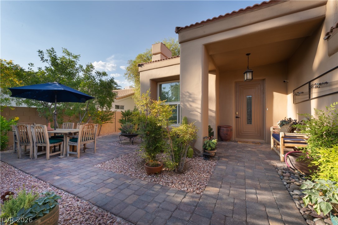 2108 Inverness Drive Henderson, NV 89074 - Photo 8 of 46 Doorway to property featuring stucco siding, a tile roof, a chimney, a patio, and outdoor dining space