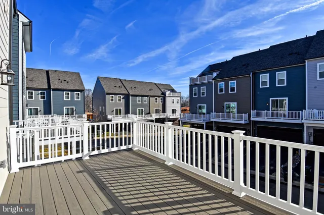 a view of a hallway with a white stove and a refrigerator