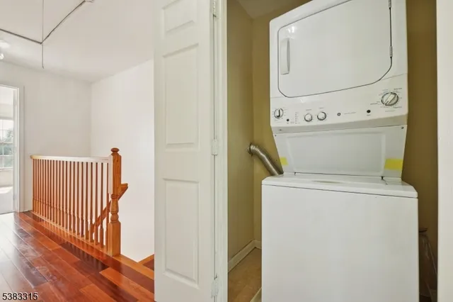 a view of washer and dryer with wooden floor