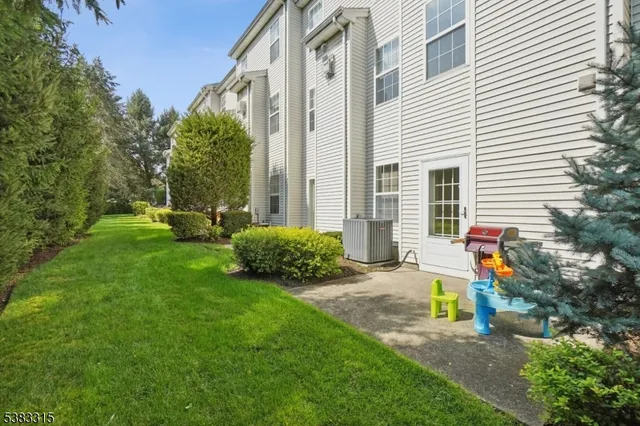 a view of a house with backyard and sitting area