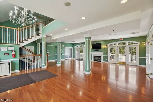 a view of an entryway with a floor to ceiling window and wooden floor