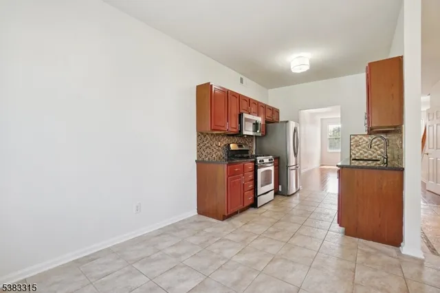 a kitchen with stainless steel appliances a refrigerator and stove